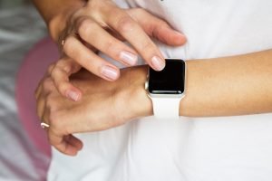 Closeup photo of Woman hands with manicure using smart apple watches