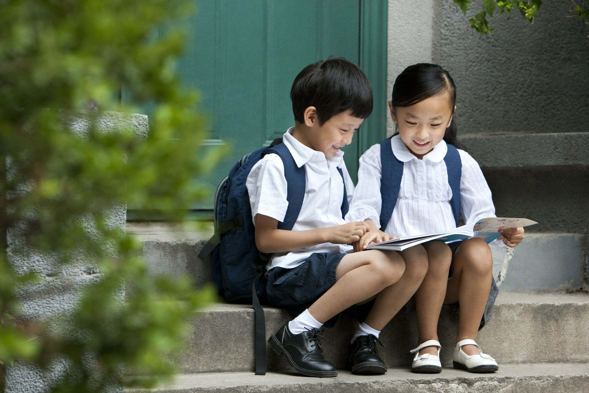 Two school children studying outside