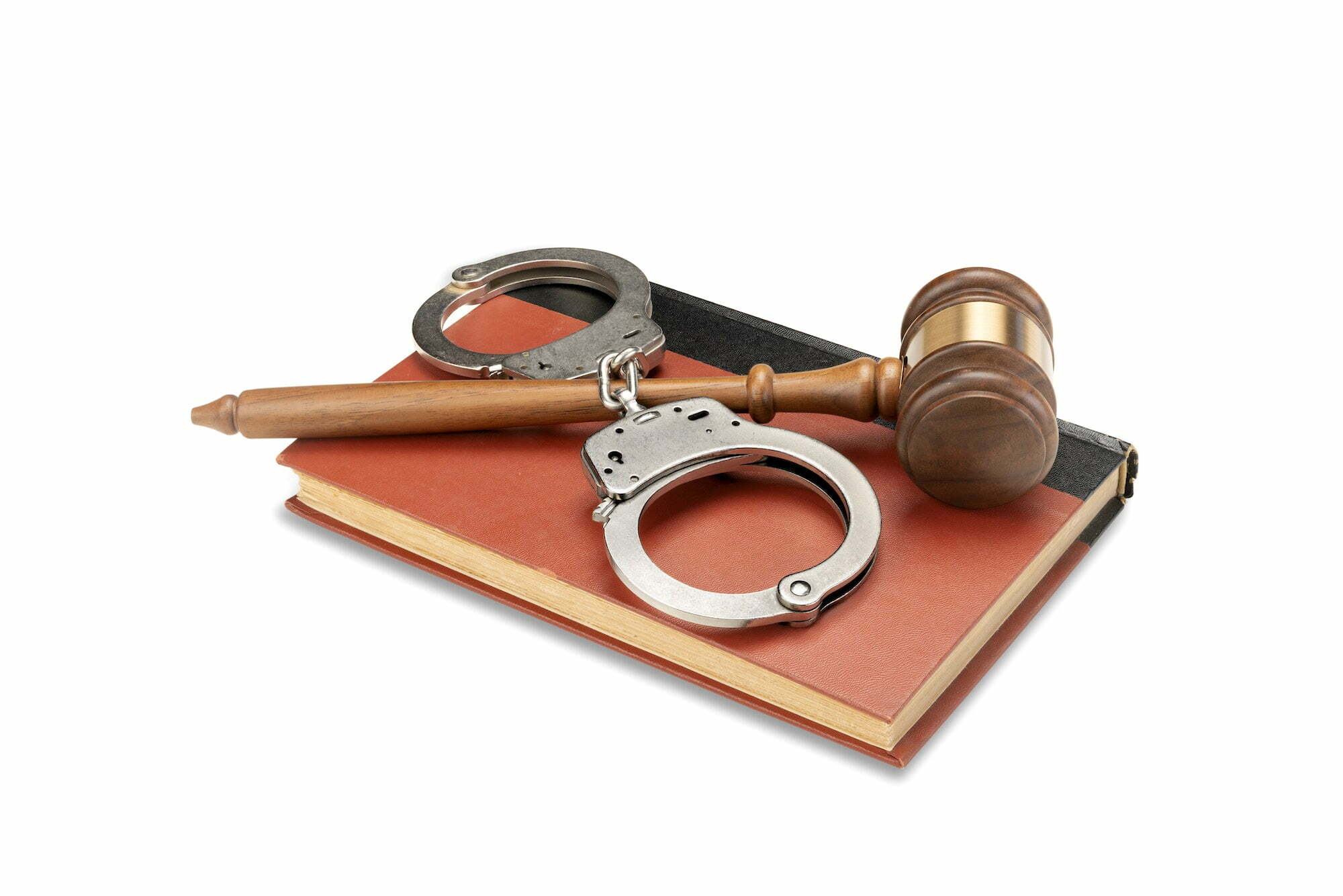 Gavel and handcuffs on law book